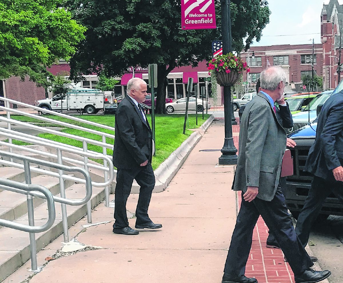 Brad Cooper leaves the Hancock County Courthouse as a convicted felon, removed from his elected job as Johnson County Prosecutor, on Wednesday afternoon. Michele Holtkamp | Daily Journal