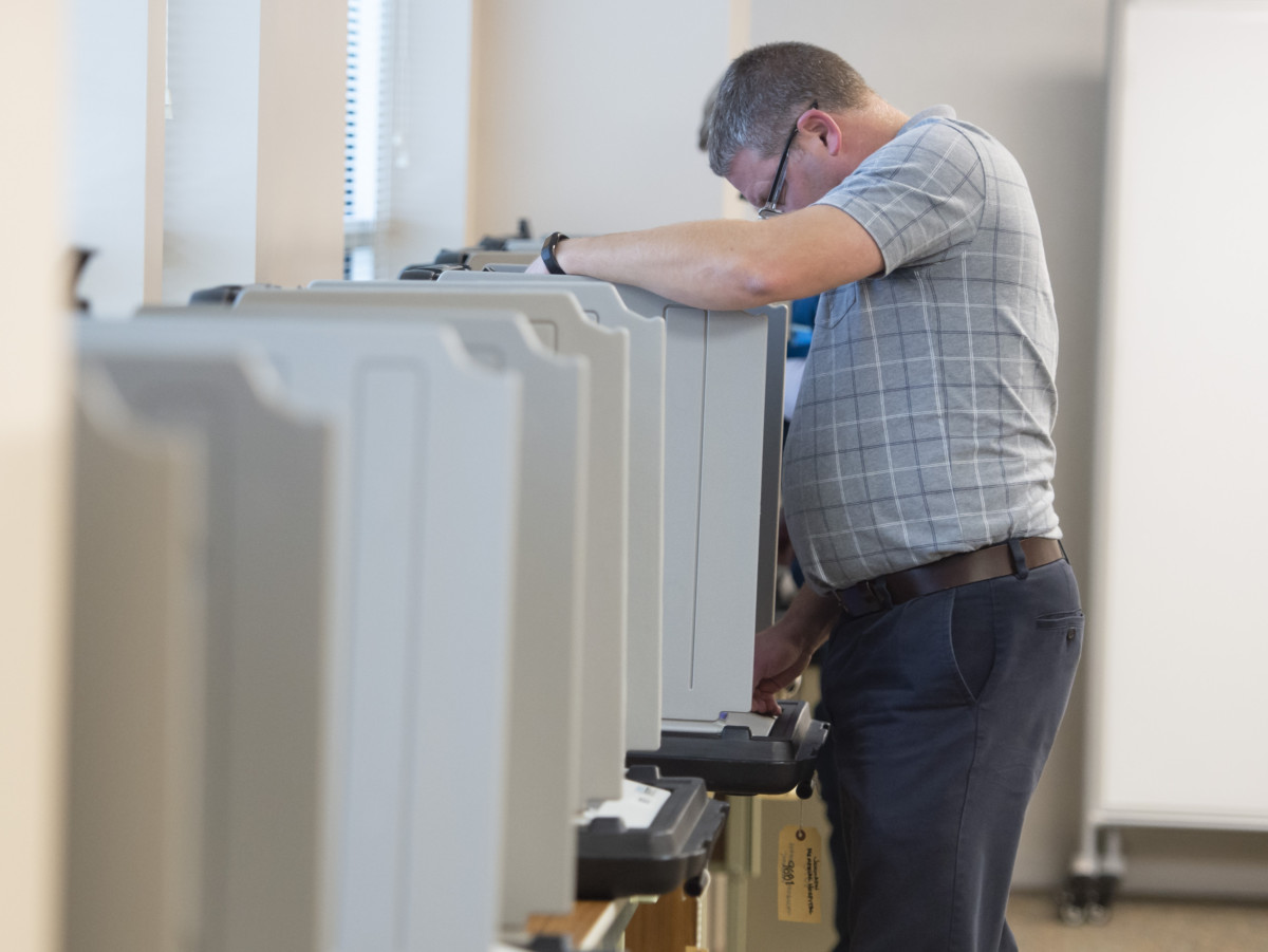 A voter castes his ballot on Tuesday at Johnson County Memorial Hospital.