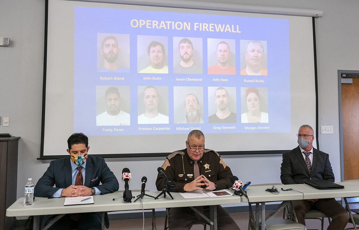 L-R Johnson County prosecutor Joe Villanueva, Sheriff Duane Burgess and Major Damian Katt hold a news conference Friday at the Johnson County Sheriff's Office's Training Center to discuss 10 child solicitation arrests made this week as part of Operation Firewall.