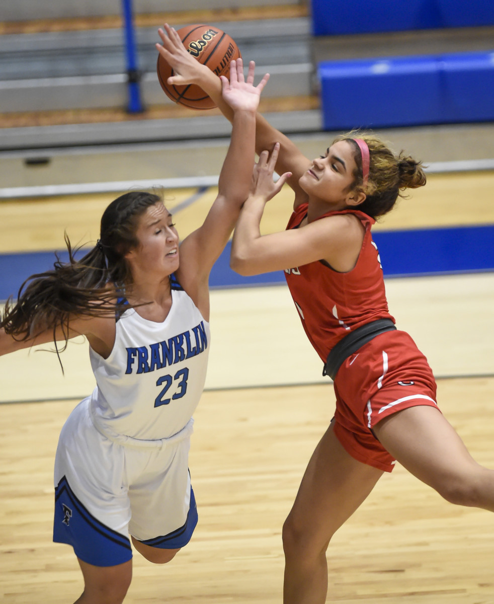 Franklin senior Kyra Baker fouls Center Grove freshman Aubrie Booker on Tuesday as she attempts a shot under the basket during Center Grove’s 29-30 loss at Franklin Community High School.