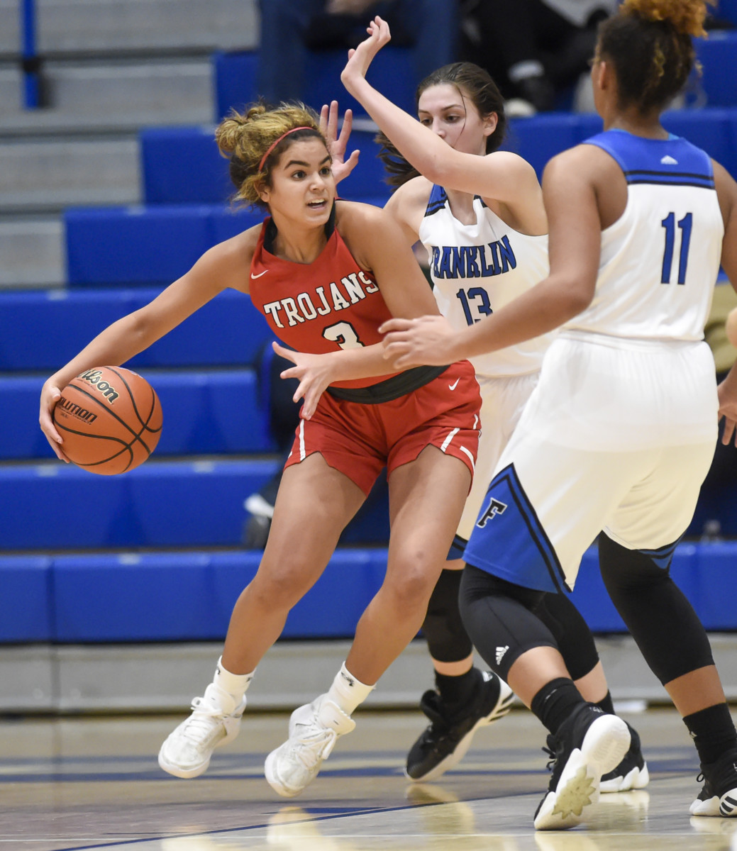 Center Grove freshman Aubrie Booker attempts to drive around Franklin freshman Scarlett Kimbrell on Tuesday during Center Grove’s 29-30 loss at Franklin Community High School.