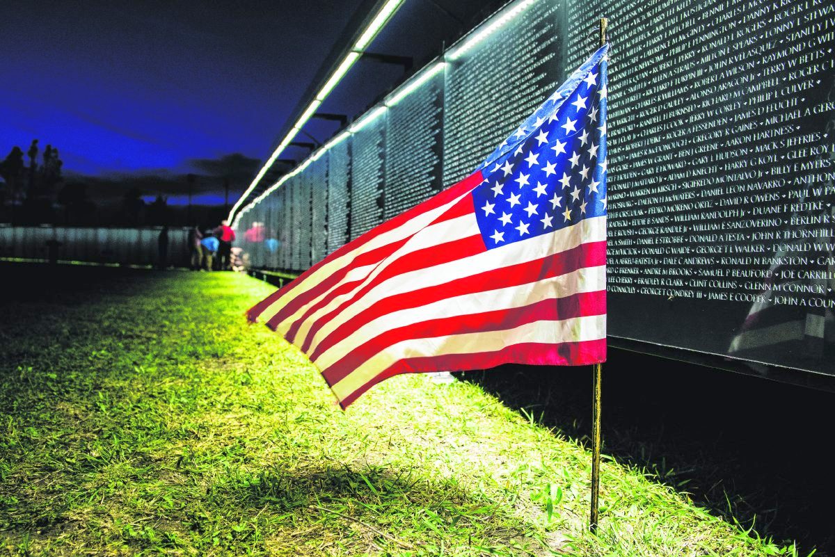 The Wall That Heals seen at night during a previous stop. The exhibit, a replica of the Vietnam Veterans Memorial in Washington D.C., is coming to the Johnson County fairgrounds from June 3 to 6. Submitted photo from the Vietnam Veterans Memorial Fund.