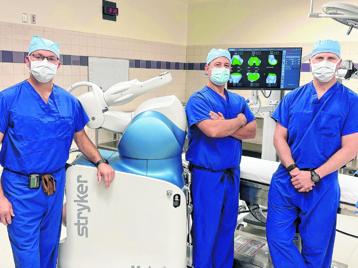 From left,Greenwood Orthopaedics surgeons Dr. Kurt Martin, Dr. Kevin Julian and Dr. Evan Armington stand next to the Mako SmartRobotics system at Community Hospital South on June 4. The robotic system gives surgeons more precision and better information for patients in need of knee or hip replacement. Submitted photo.