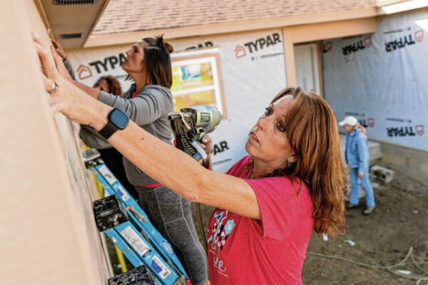 Habitat for Humanity group building home for single mom