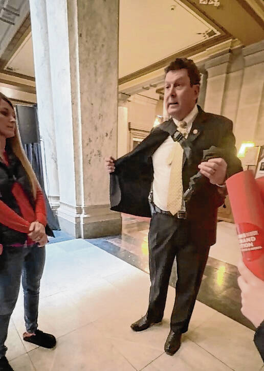 State Rep. Jim Lucas shows gun to students Tuesday at the Statehouse
